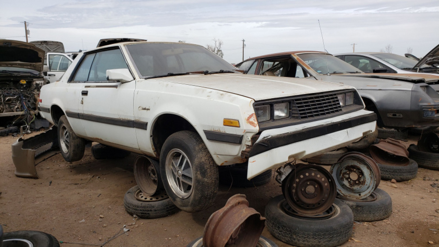 autos, cars, classic cars, dodge, 1982 dodge challenger in colorado junkyard