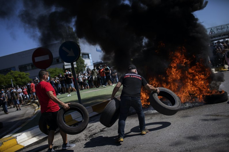 autos, cars, nissan, car news, nissan workers burn tyres at gate of barcelona factory after closure announced