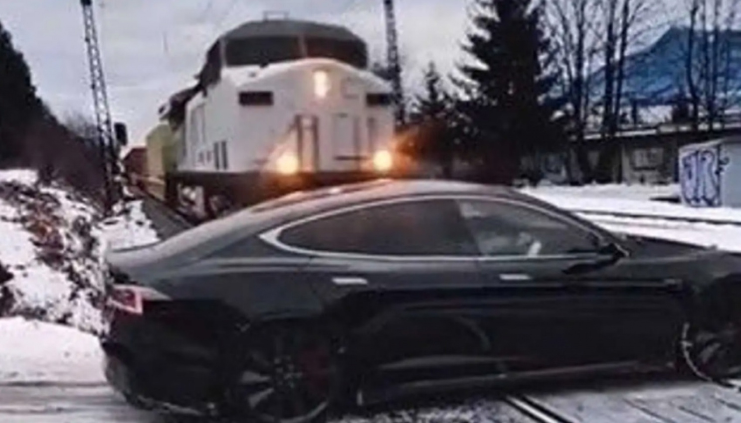 autos, cars, tesla, watch: tesla drives away after being ‘run over’ by train