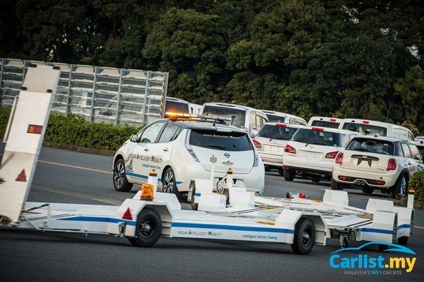 autos, cars, nissan, auto news, autonomous driving, intelligent vehicle towing, ivt, leaf, nissan leaf, nissan-nscr, nissan motors japan introduces fully-automated towing system at oppama plant