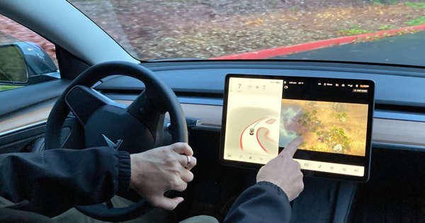 tesla disables 'passenger play' video games in moving cars