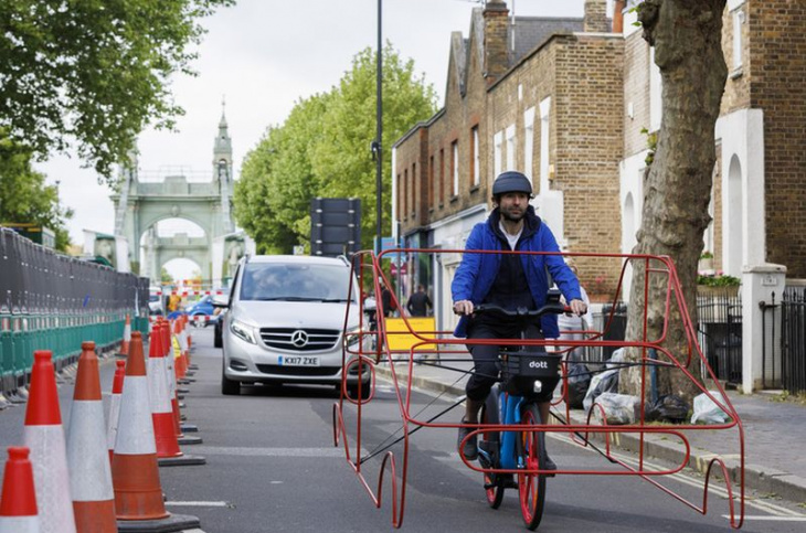 cyclists in car frames protest 'absurdity' of vehicles hogging roads