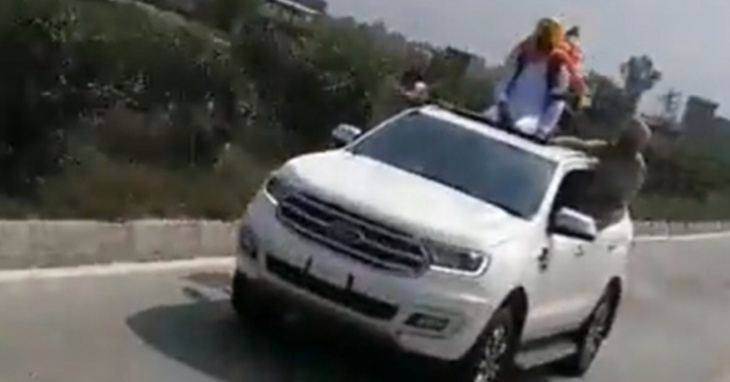 punjab transport minister travels sitting on ford endeavour's sunroof 
