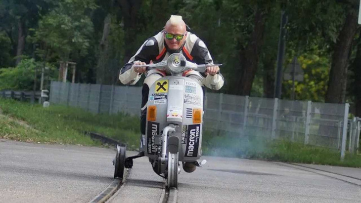 stuntman sets world record by riding vespa on railroad tracks