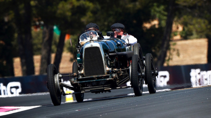 sebastian vettel dons flat cap, drives 100-year-old aston gp racer