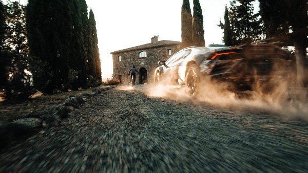 lamborghini sterrato takes on a dirt bike in first teaser for rally-prepped supercar