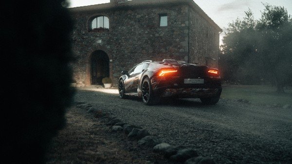 lamborghini sterrato takes on a dirt bike in first teaser for rally-prepped supercar