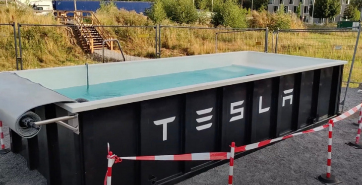 tesla deploys swimming pool at supercharger station