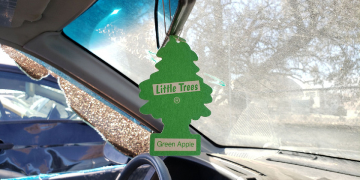 green apple car-freshner little trees in junkyard cars