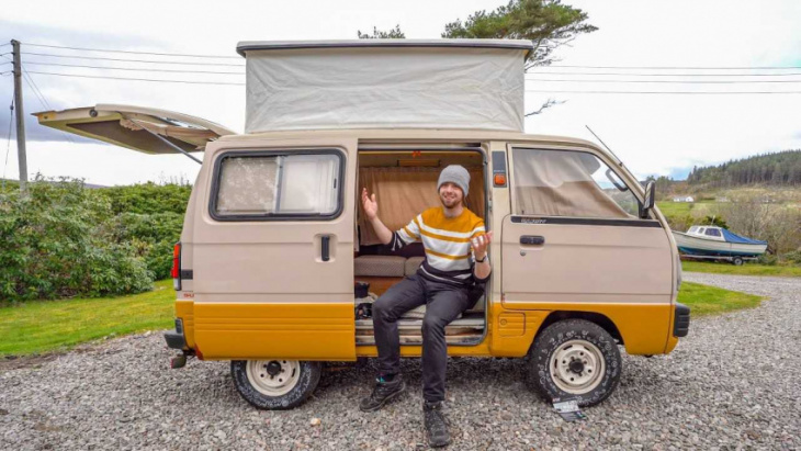 tiny suzuki camper van with a pop-top and mini stove is adorable