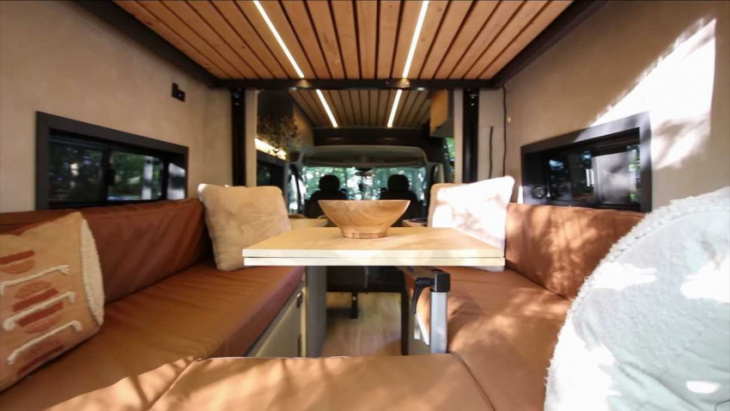 ram promaster custom camper has unique layout with two large beds