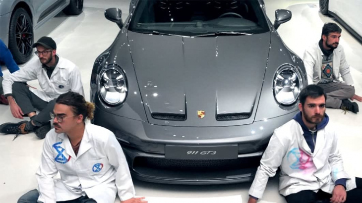 climate protesters glue themselves to porsche museum in germany