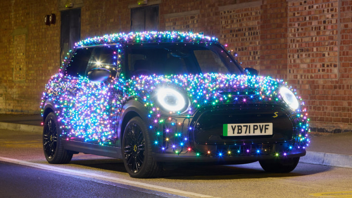 ‘festive mini’ dresses up in 3,000 christmas lights for charity