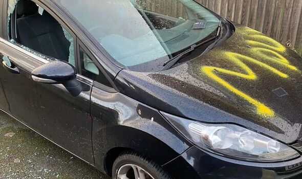 cars spray painted with 'move' and windows shattered in overnight rampage