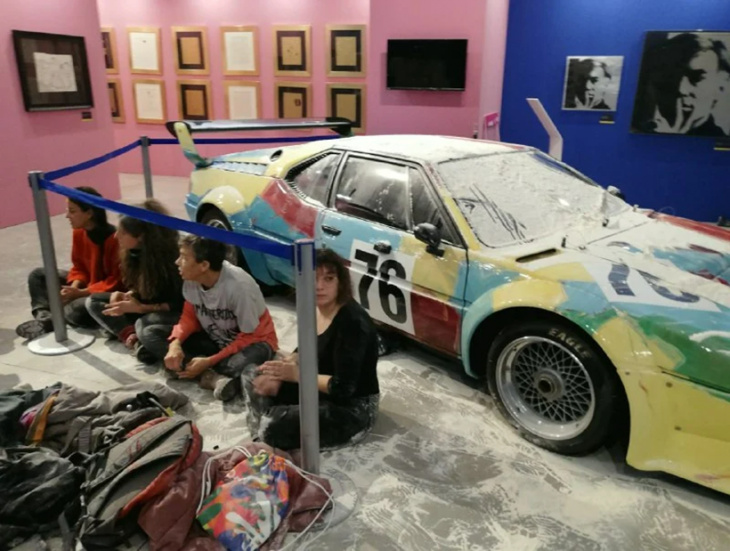 climate activists throw flour on bmw painted by andy warhol