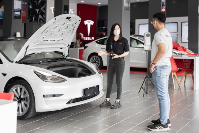 autos news, tesla, ev rivals absorb costs after china pulls plug on subsidy