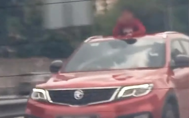auto news, proton x70, viral video, x70 child out of sunroof, police hunting down owner of red proton x70 for allowing kid to go on a sunroof joyride