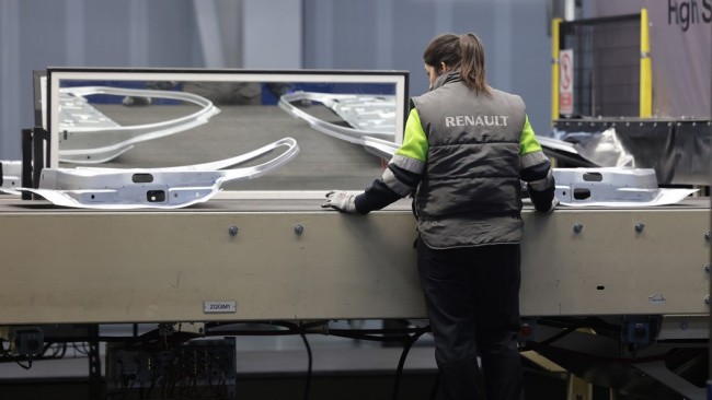 Renault factory: worker inspecting stamped panels