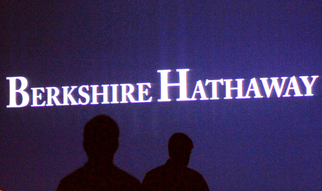 File photo of Berkshire Hathaway shareholders walking by a video screen at the company's annual meeting in Omaha