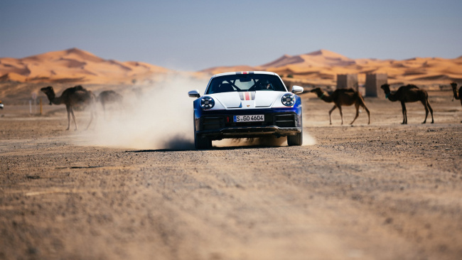 Porsche 911 Dakar and camels in the desert