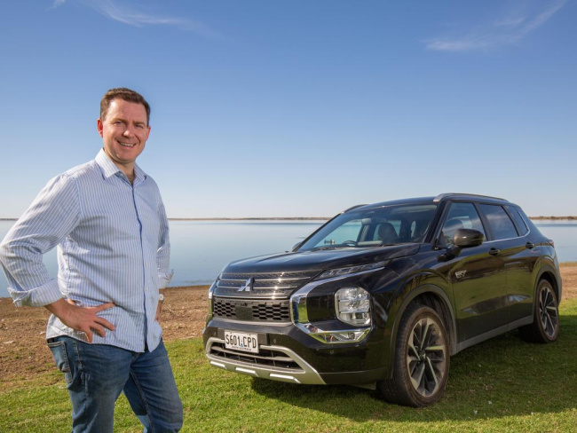 Advertiser reporter Andrew Hough with the Mitsubishi Outlander Aspire at Lake Bonney. Picture: Ben Clark, Technology, Motoring, Mitsubishi Outlander test drive: What’s it like behind the wheel of a plug-in hybrid electric car on SA roads?