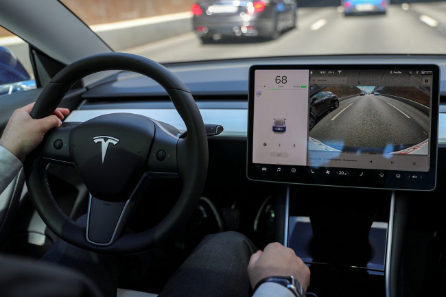 tesla pauses rollout of driving-assist software