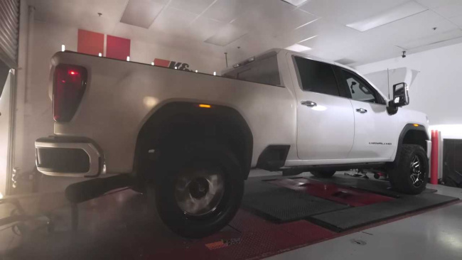 A close look at the back of a GMC Sierra Denali HD diesel pickup as exhaust soot fills the room during a dyno pull.
