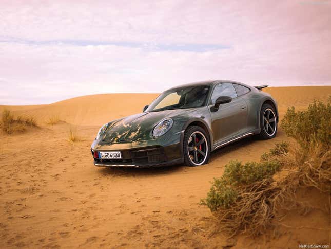 The 2023 Porsche 911 Dakar drives on a sand dune.