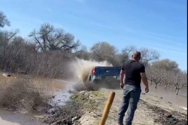 video, trucks, watch farmer drive ford and chevy into the levee to save farm from floods