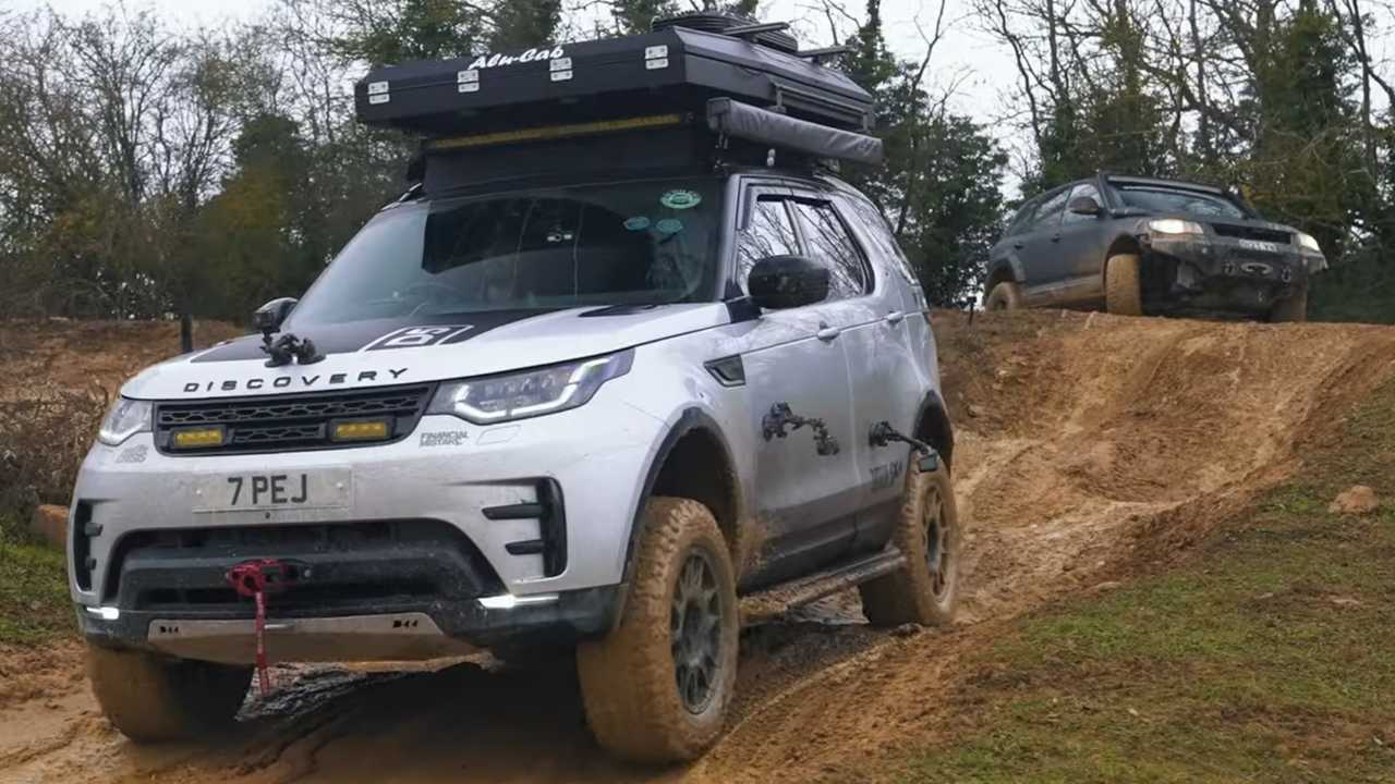 A Land Rover Discovery battles a VW Touareg in off-road challenges.