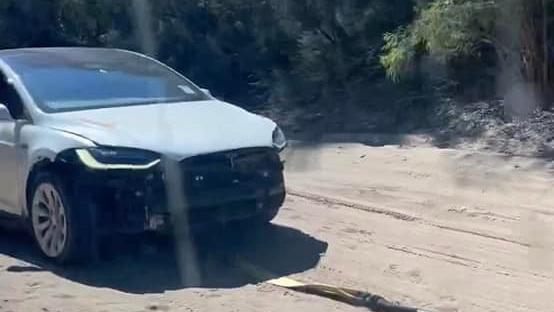 rented tesla model x gets stuck on beach, front then ripped off car