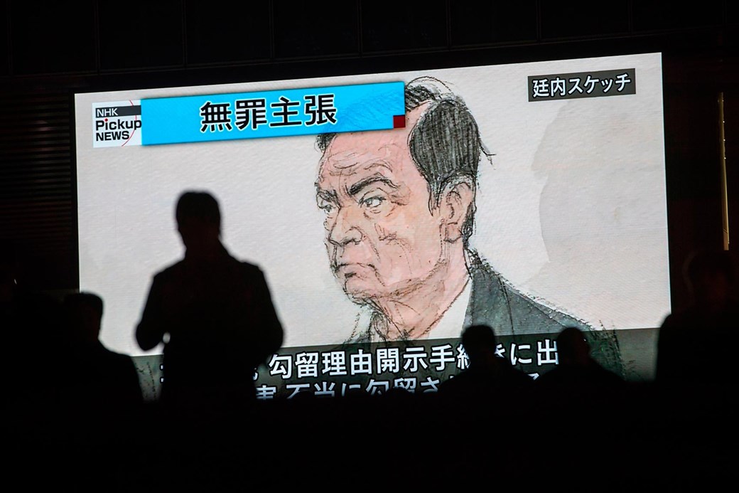 An artist's impression of Carlos Ghosn in court in Tokyo flashes up on Japanese TV (Getty)