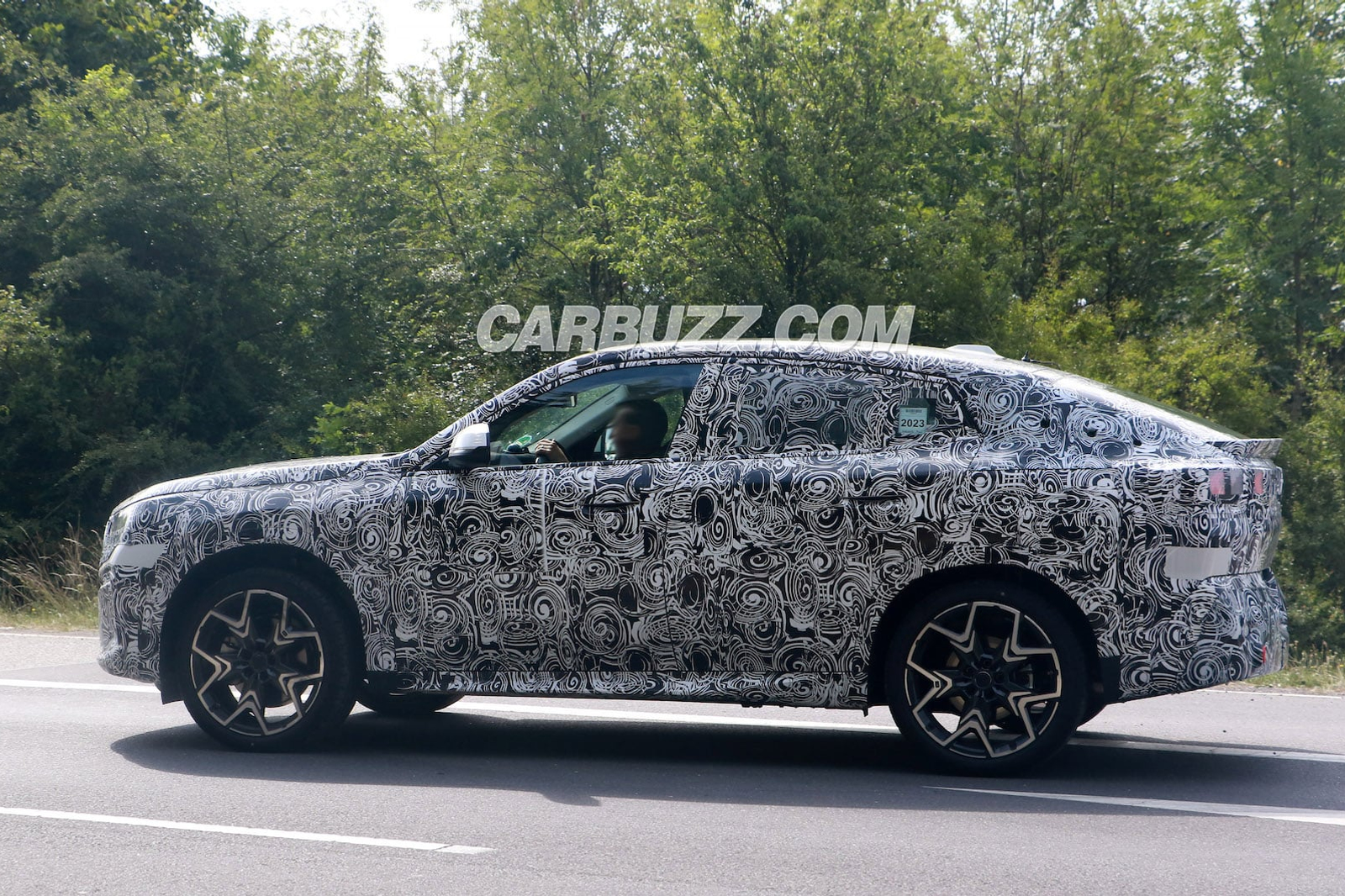 spy shots, new bmw x2 peels back camo to reveal smiling face