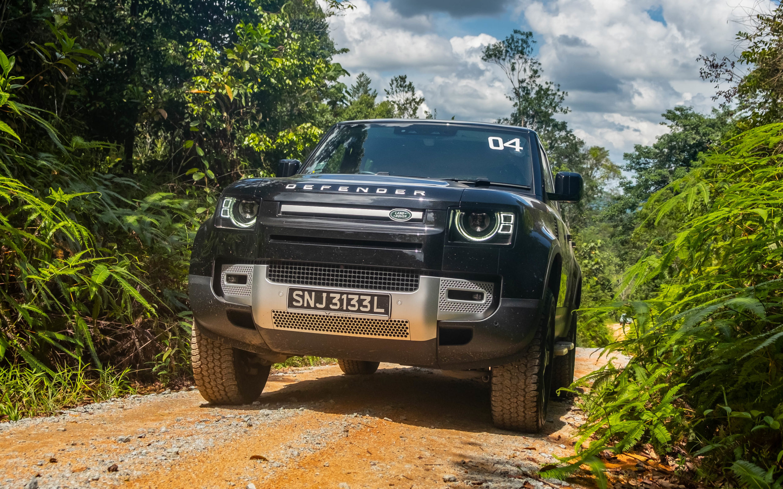 defending its title: the new land rover defender shows us how it's done on desaru's dirt trails