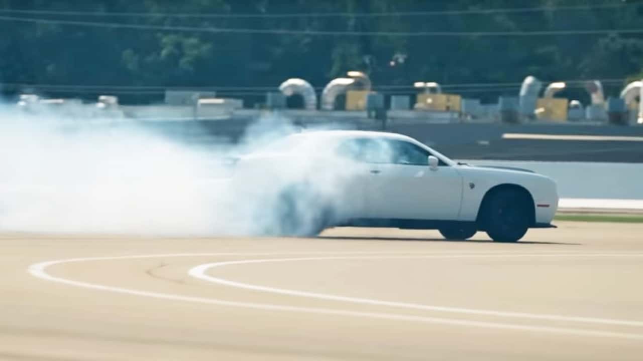 A Dodge Challenger Hellcat on a race track.