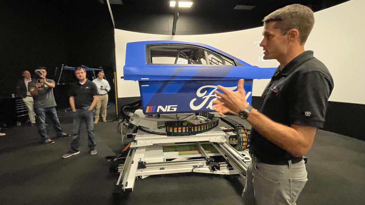 Test driver David Ragan with Ford's simulator in North Carolina. Photo: David McCowen, Promotional models are a rare sight in Nascar. Photo: David McCowen, Nascar teams pay former athletes six-figure salaries to perform lightning-fast pitstops. Photo: David McCowen, Wood Brothers Racing co-owner Eddie Wood at Richmond Raceway. Photo: David McCowen, Nascar pit crews play a vital role – many are former athletes. Photo: David McCowen, A strong crowd turned out to Richmond Raceway last weekend. Photo: David McCowen, Chris Buescher, driver of the #17 Fastenal Ford, celebrates with a burnout after winning the NASCAR Cup Series Cook Out 400 at Richmond Raceway. Photo: Sean Gardner / GETTY IMAGES, Nascar races are closely-fought contests. Photo: David McCowen, Shane van Gisbergen celebrates with the checkered flag after winning at the Chicago Street Course. Photo: Sean Gardner/Getty Images, Technology, Motoring, Motoring News, Why Aussies are wrong about Nascar