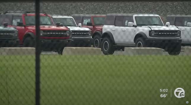 Ford Broncos sit behind a fence in Metro Detroit