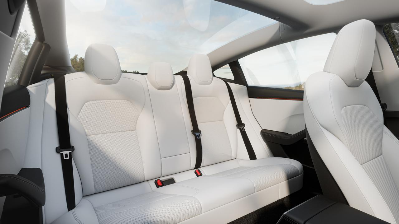 White seats are optional, but a glass roof is standard., Back seat passengers get their own touchscreen., Tesla’s popular ‘dog mode’ feature remains standard., New lights and wheels are part of the deal., Tesla has upgraded the Model 3 for 2024., Technology, Motoring, Motoring News, How Tesla is fighting back with the new Model 3