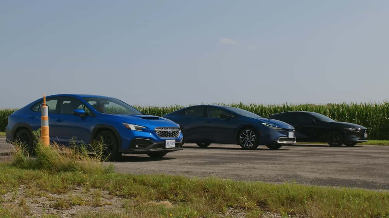 A Toyota Prius, Mazda3, and Subaru WRX parked in a row.