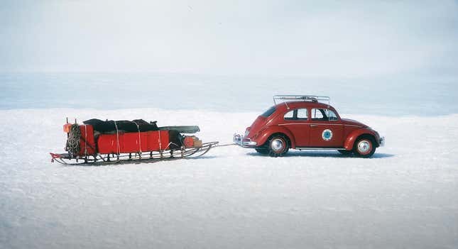A red volkswagen beetle hauling a sled on a ice sheet in Antarctic