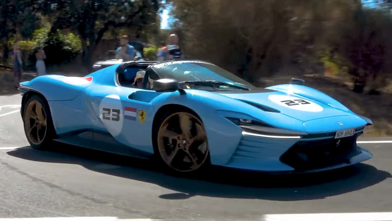 Hypercars fly by camera leaving Spanish event. 