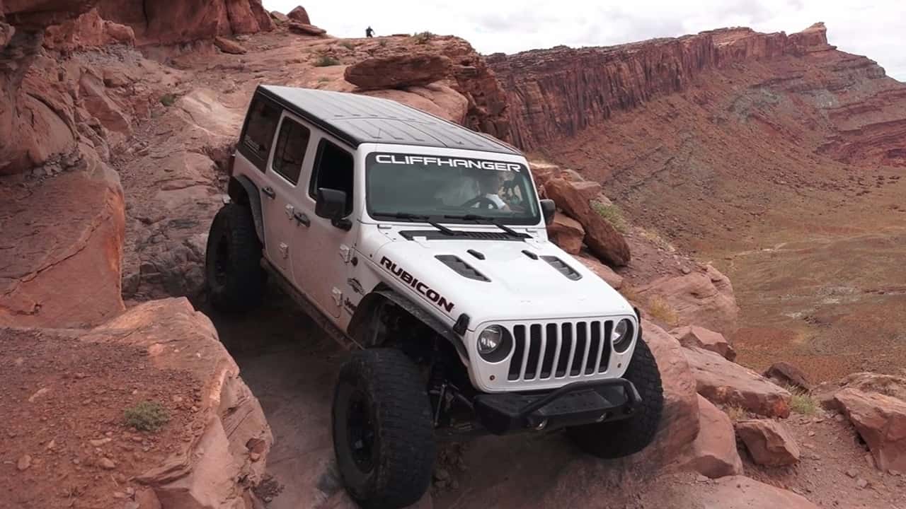 A Jeep Wrangler navigates a rocky section of Cliffhanger Trail