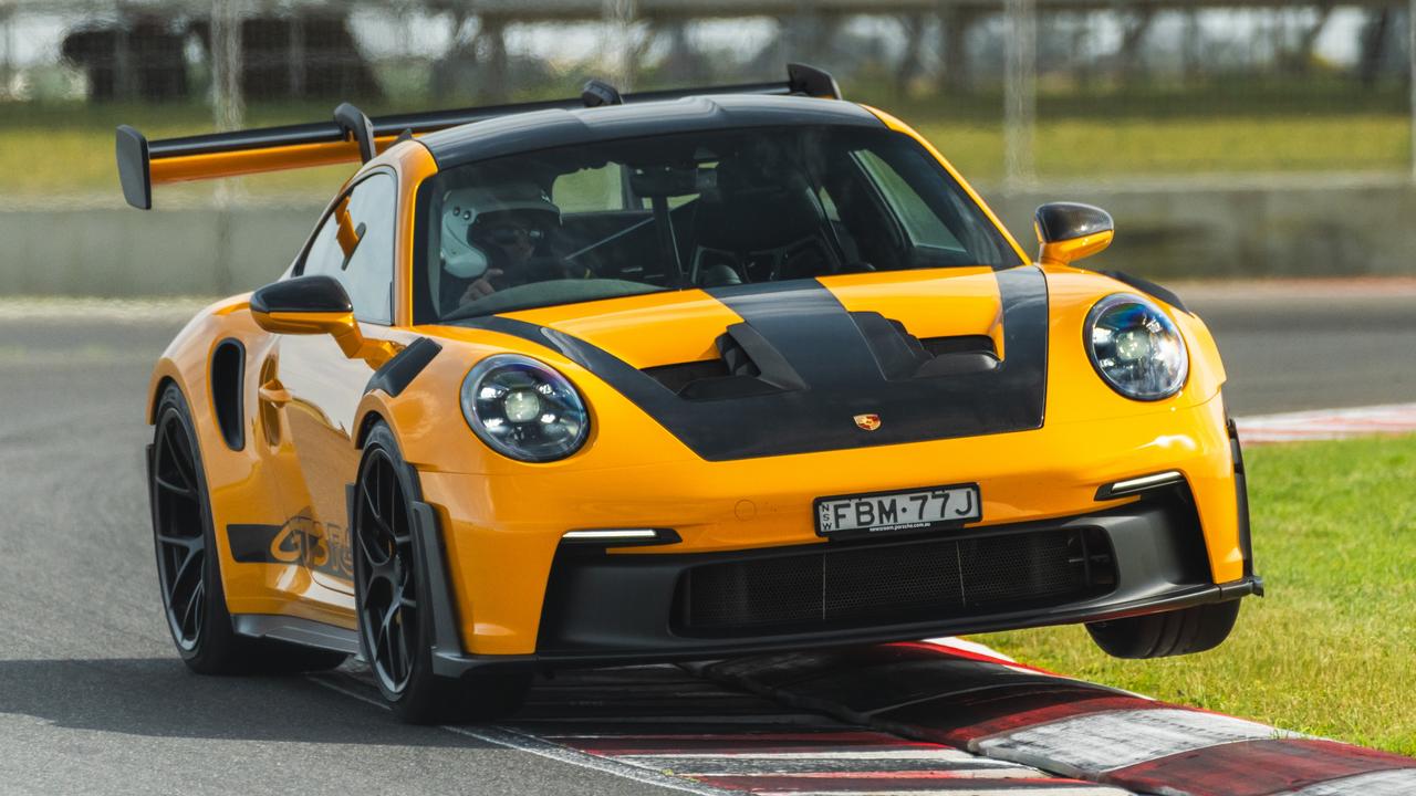 Porsche’s wildest machine shines on track., The GT3 RS comes with racing harnesses and a roll cage. Bring your own helmet., A huge wing helps the car turn corners - and turn heads., Porsche’s 911 GT3 RS has an uncomproming approach to aerodynamics., Technology, Motoring, Motoring News, Why the Porsche 911 GT3 RS is the wildest car on sale