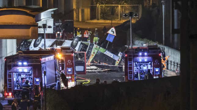 Emergency crew members work at the scene after a bus accident near Venice on October 04, 2023 in Mestre, Italy. A bus belonging to the transport company La Linea plunged from an overpass between Mestre and Marghera, plunging 10 meters and catching fire shortly before 8 p.m. At least 20 people are reported killed, including some minors, and many others injured.