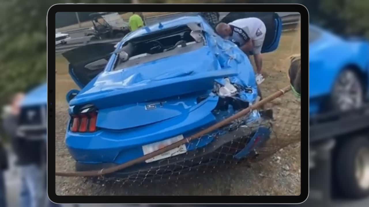 Rear view of a heavily damaged 2024 Ford Mustang.