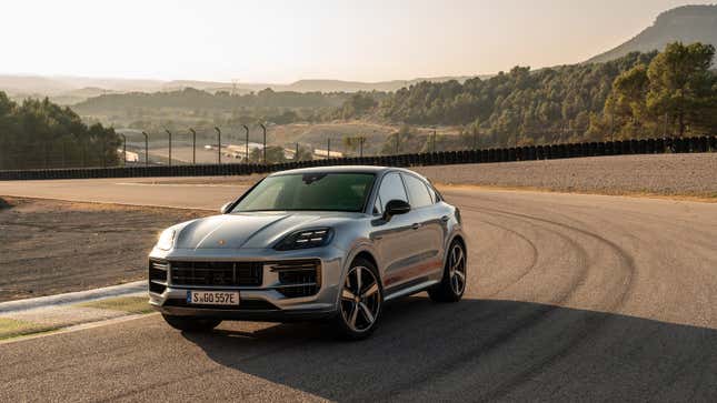 A gray 2024 Porsche Cayenne Turbo E-Hybrid with GT package sits on a track in Spain
