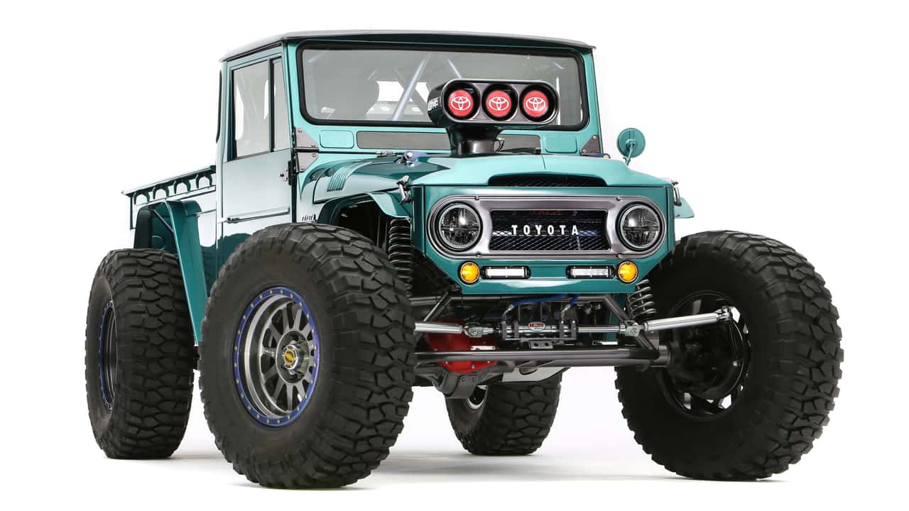 this wild toyota land cruiser has a nascar engine, five wheels, and a tank tread