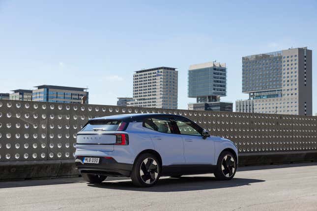 2024 Volvo EX30 parked on a roof top with a metal fence behind it. 