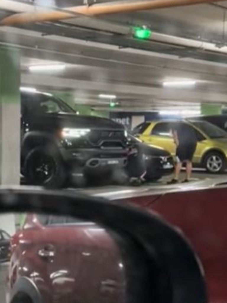 The said she hoped they left a note and called for the cars to be banned. Picture: TikTok, The woman raged at the ‘Tonka truck crew’ in the video. Picture: TikTok, Two men could be seen attempting to reattach the front bumper bar. Picture: TikTok, The large pickup truck allegedly ‘sideswiped’ a sedan while parking. Picture: TikTok, Technology, Motoring, Motoring News, Pickup ‘monster truck’ carpark sideswipe crash sparks outrage