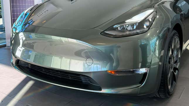 An image of a Tesla Model Y with a forest green wrap